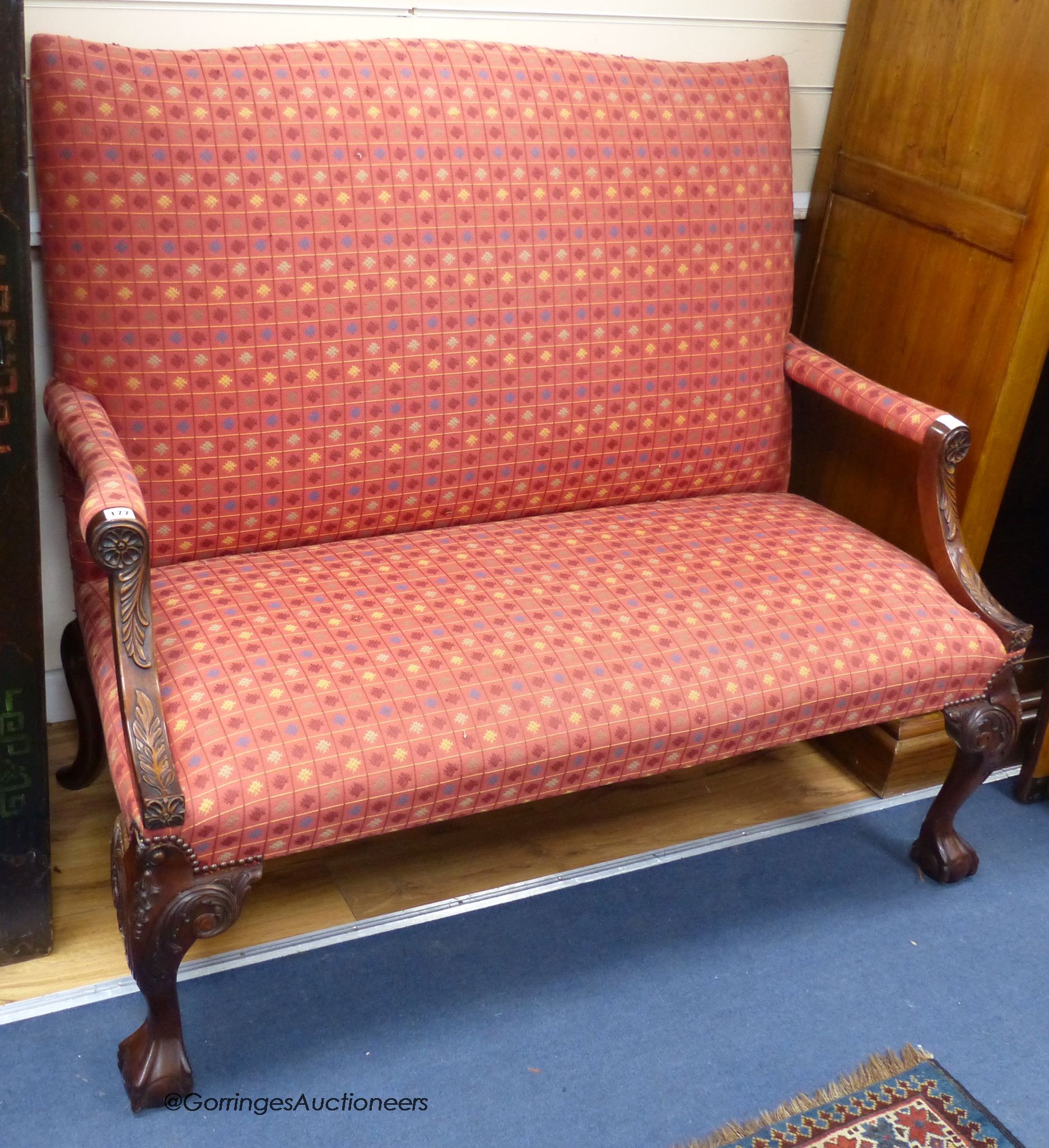 A George III style carved mahogany settee, on cabriole legs, length 130cm, depth 74cm, height 110cm
